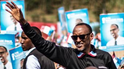 Paul Kagame waves at a rally