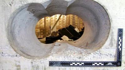 Met Police image showing hole in concrete wall of vault