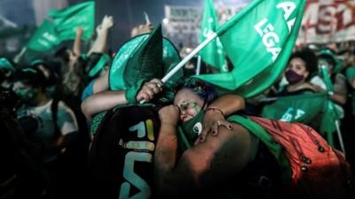 Demonstrators celebrate outside the Senate in Buenos Aires