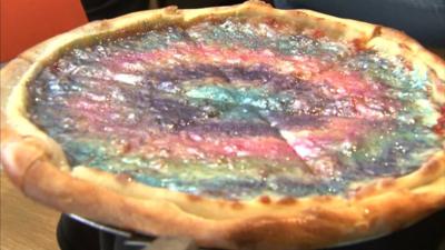 A pizza covered in rainbow glitter