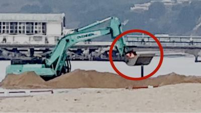 Worker being carried inside bucket of a digger