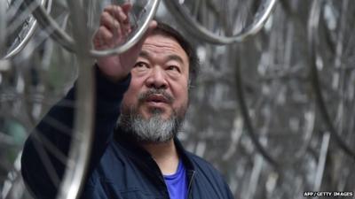 Chinese artist Ai Weiwei touches his sculpture "Forever" at the base of the the Gherkin tower