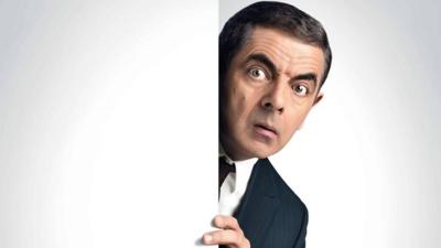 Still from Johnny English shows his peaking out from behind the door