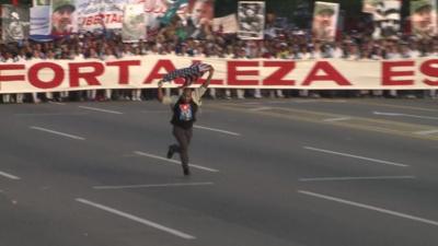 A man ran through Revolution Square in protest before being bundled to the ground and led away.