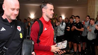 Wales manager Robert Page and captain Gareth Bale are applauded by Wales' rugby union players