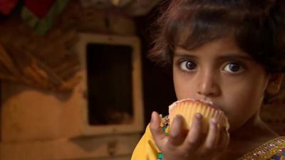 Young girl eating cake