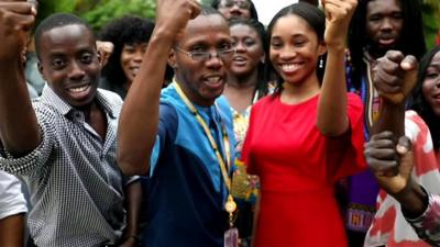 BBC Pidgin team raise their arms together