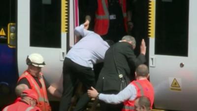 Commuters being helped from train