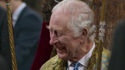 King Charles laughs