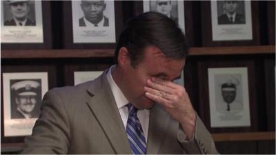 John Cranley wipes away tears.