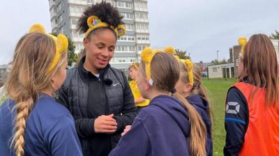 Demi Stokes speaking to pupils at Dame Dorothy School