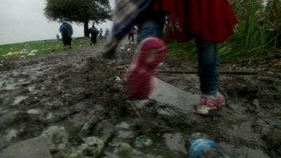 Migrant walking in mud in Macedonia