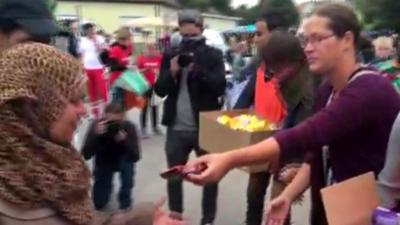 Nickelsdorf locals hand out food and drink to migrants