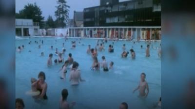 1970s era footage showing lots of people in a swimming pool