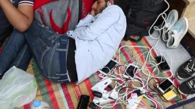 Refugees charging phones