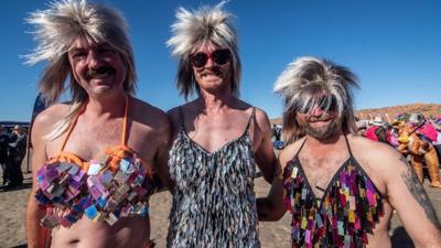 Men dressed up in Tina Turner costumes