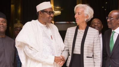 IMF chief Christine Lagarde (R) shakes hands with Nigeria's President Muhammadu Buhari