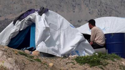 Man sitting near tent on Chios