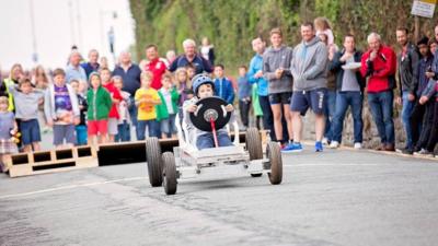 A soapbox makes its way down the course