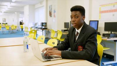 School reporter Ben at his laptop