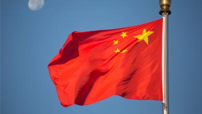 A Chinese flag flying over Tiananmen Square in Beijing