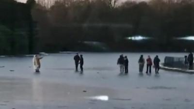 People skating on icy lake in Liverpool