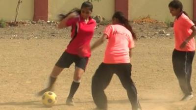 Girls playing football