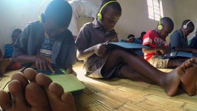 School children in Malawi using educational apps on tablets