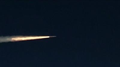 STREAK OF LIGHT AS MISSILE PASSES ACROSS DARK SKY