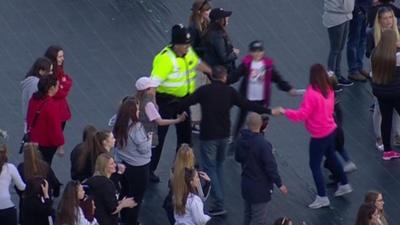 Darlington police officer PC Paul Taylor dances with children at One Love Manchester