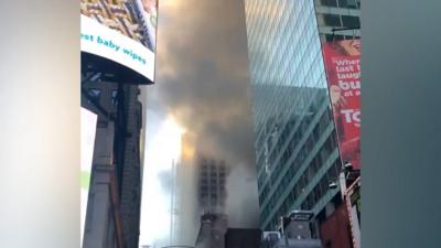 A hotel in New York's Times Square was evacuated after a fire broke out at a neighbouring restaurant.