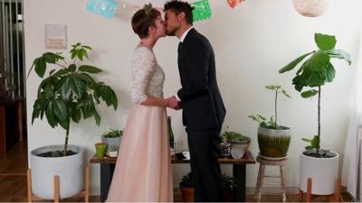 A couple getting married at home with a virtual wedding ceremony