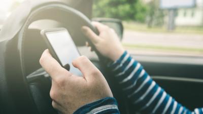 A person driving while using a mobile phone