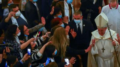 Pope greeted by crowds of people