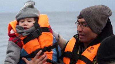 Migrants in life vests on a boat