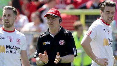 Mickey Harte (centre) gathers his players together at half-time at Clones