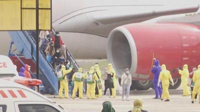 Indonesian evacuees from Wuhan being sprayed with disinfectant