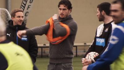 Newcastle United's Daryl Janmaat puts on a bib