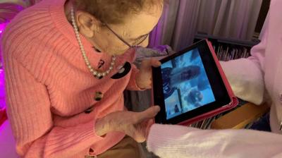 Edna watches a birthday message from Billy Connolly