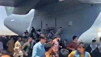 People trying to board USAF aeroplane at Kabul airport