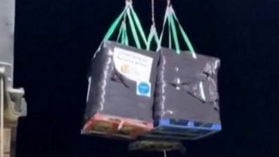 Crates of aid winched ashore in Gaza