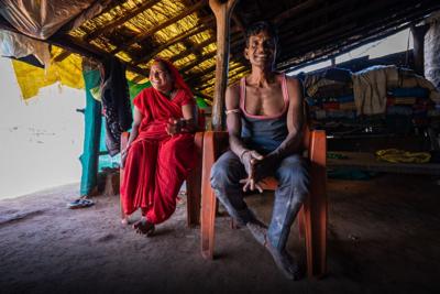 A couple in Bhopal in their mud house