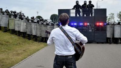 Rock musician Pit Pawlaw singing at a protest rally in Belarus