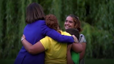 Daad's family hugging.