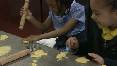 Primary school children making pastry shapes