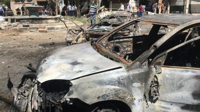 A car damaged in Tahrir square following the blast