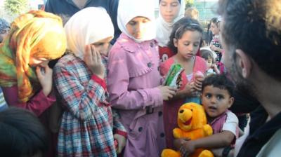 Syrian children holding toys