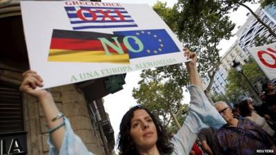 A woman holds a banner supporting Greece during a pro-Greece protest in front of the European Union office in Barcelona, Spain, July 3, 2015.