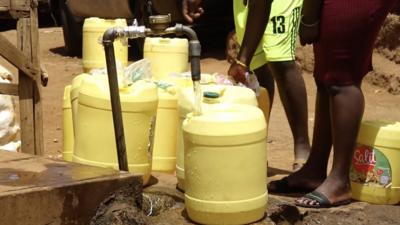 People fetching water at a water vendors tap