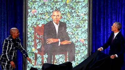 Barack Obama (R) and artist Kehinde Wiley unveil his portrait during a ceremony at the Smithsonian's National Portrait Gallery